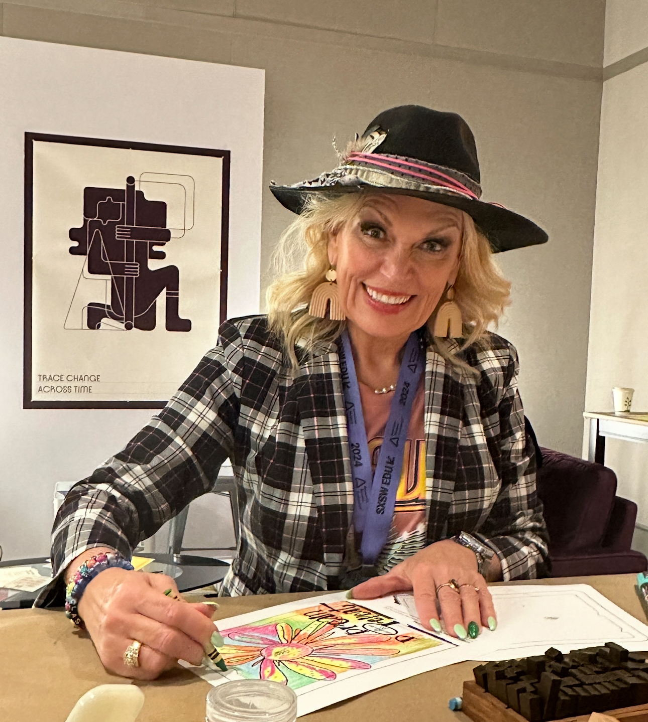 Jerri Kemble sketching and coloring at a creative studio table