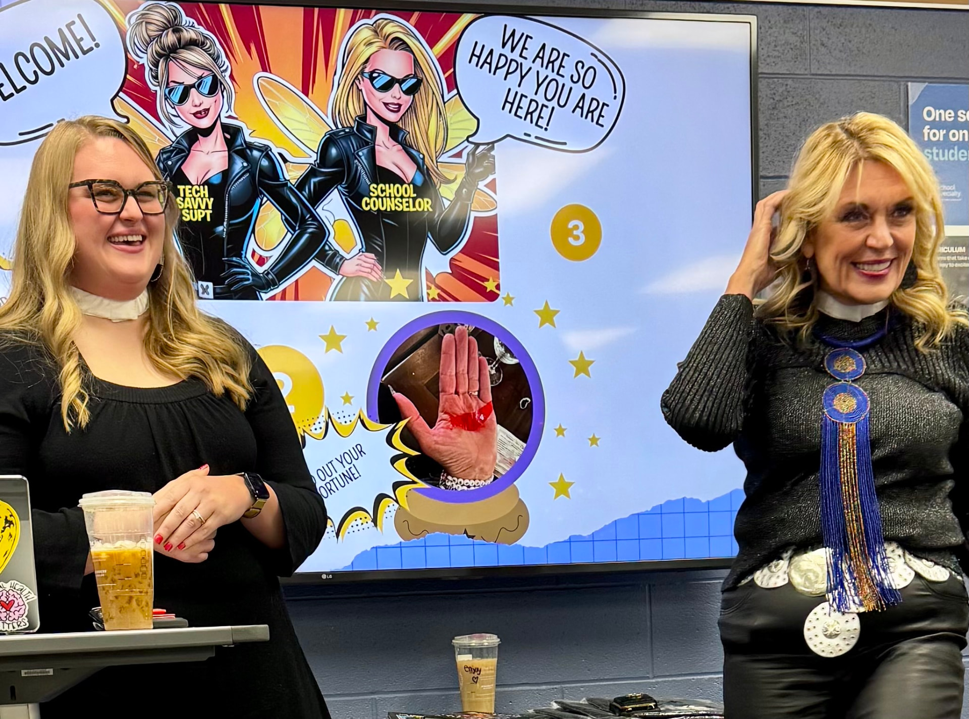 Jerri and her daughter Hanna leading a lively school-based workshop in front of a bright welcome slide.