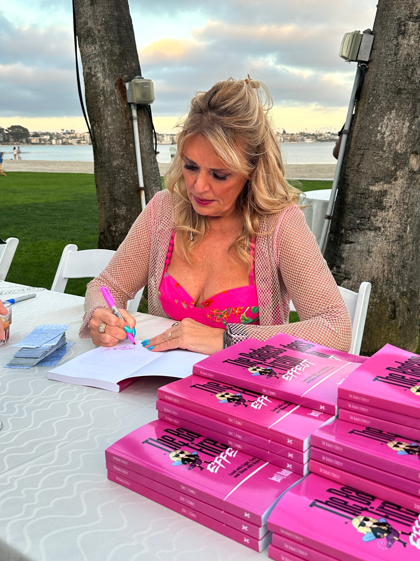 Jerri signing copies of The Badass Firefly Effect at a seaside book event